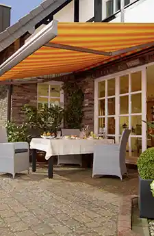 Fully extended Semina awning above outdoor furniture
